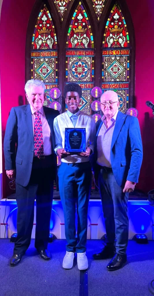 The winner of the Darby Ryan Poetry Contest School Section, Willard Vintem, with contest organisers John Grogan and Martin Quinn at Templeneiry